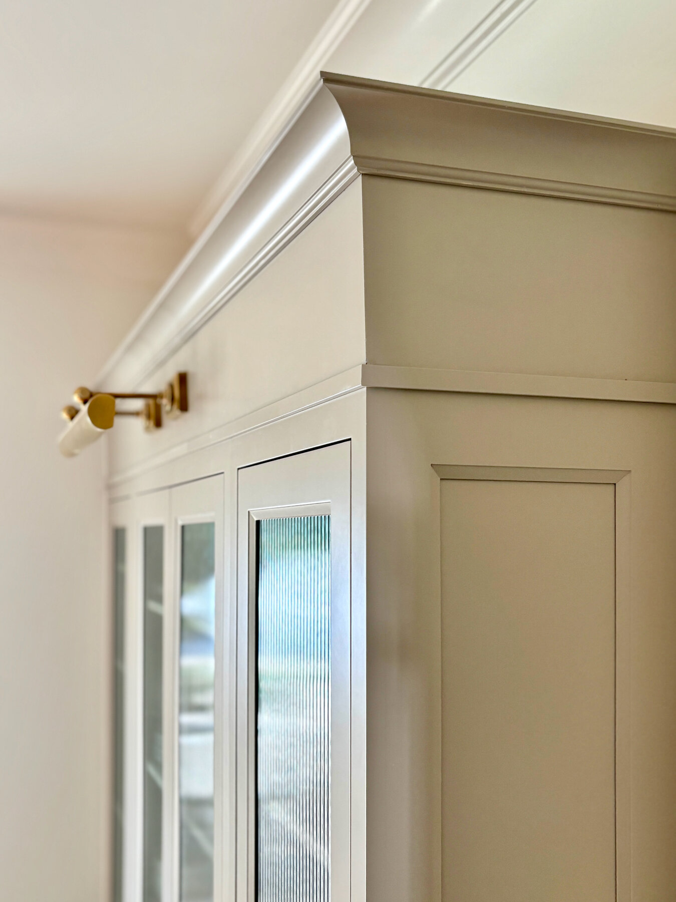 Inset cabinetry with reeded glass detail