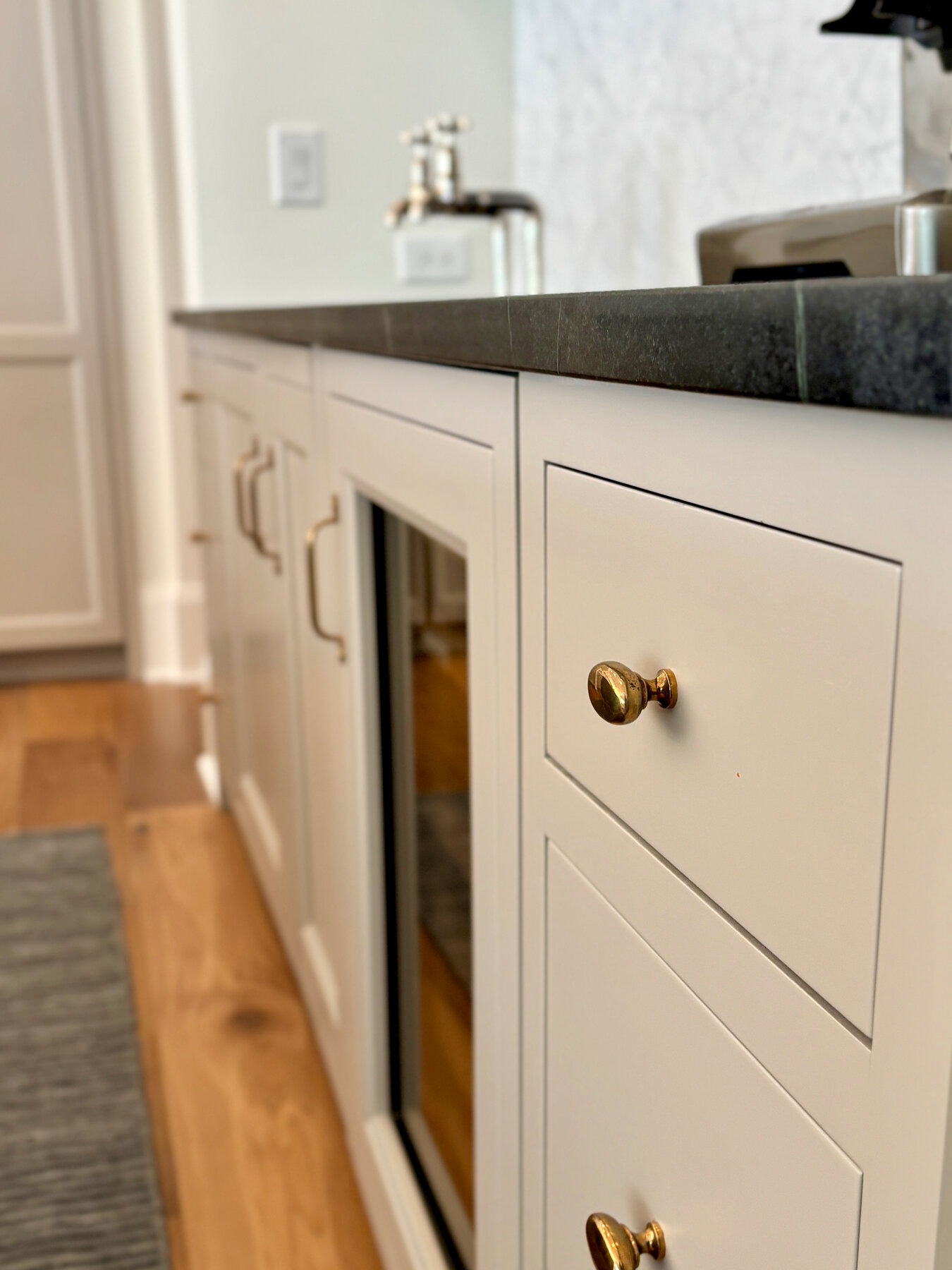Custom inset cabinetry with brass hardware detail