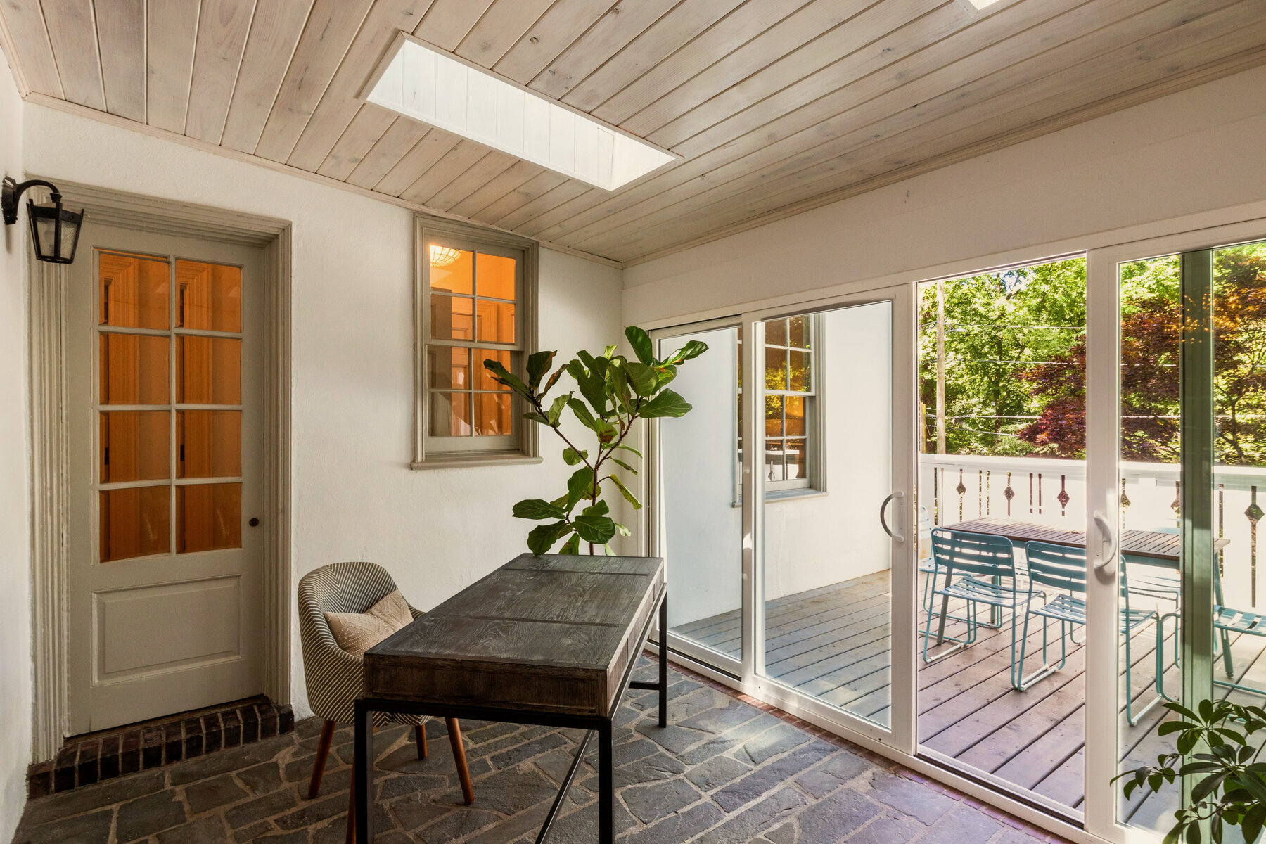 Sunroom addition with indoor-outdoor connection and skylight